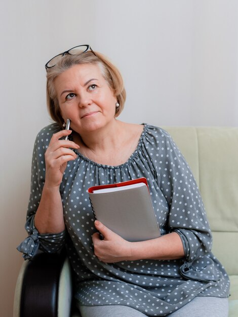 Photo portrait d'une belle pensionnée bien entretenue de 50 à 60 ans dans la chambre.