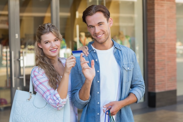 Portrait d&#39;un couple heureux montrant leur nouvelle carte de crédit