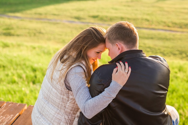 Portrait de couple hugging sur une jetée dans la nature vue arrière