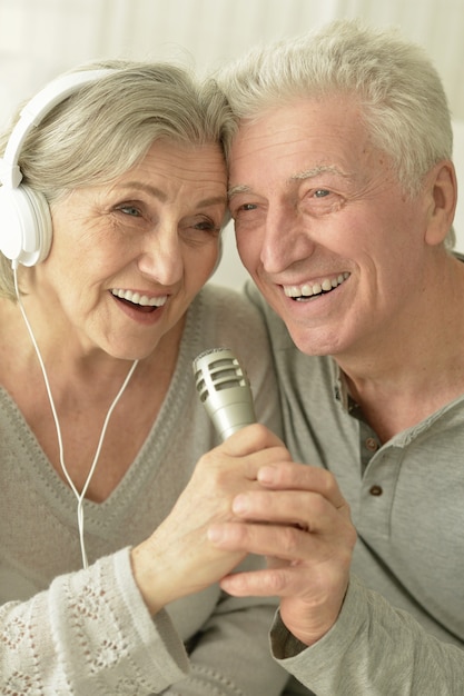 Portrait d'un couple de personnes âgées avec casque et microphone