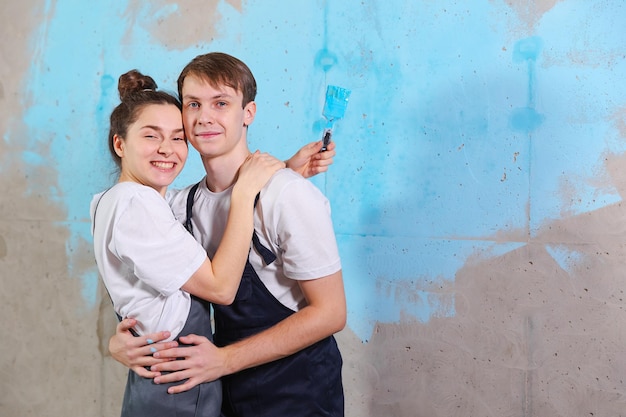 Photo portrait d'un couple souriant debout contre le mur