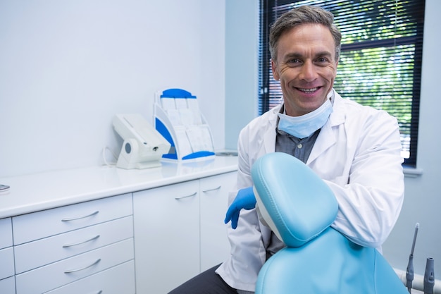 Portrait De Dentiste Souriant Debout Par Chaise