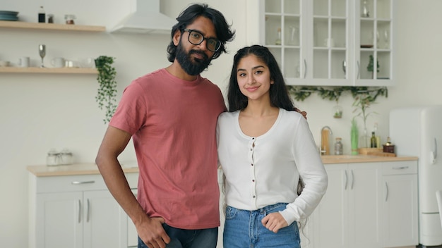 Portrait de deux personnes couple multiracial amoureux posant dans la cuisine blanche domestique hispanique arabe