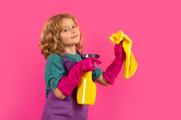 Portrait du concept de nettoyage de l'enfant développement de la croissance relations familiales Concept d'entretien ménager et de nettoyage à domicile L'enfant utilise un plumeau et des gants pour le nettoyage Studio fond isolé
