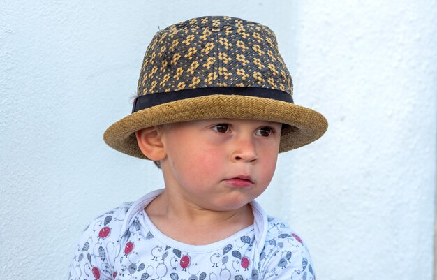 Portrait d'enfant de trois ans avec chapeau à l'extérieur