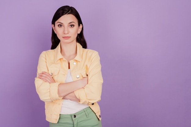 Portrait de femme d'affaires confiante les mains croisées regardent la caméra sur fond violet