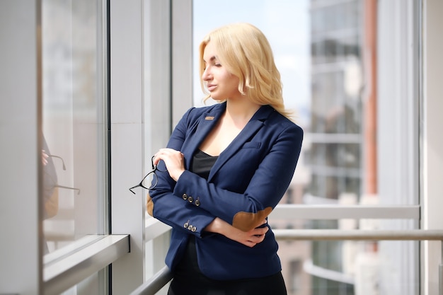 Portrait d'une femme d'affaires prospère contre la fenêtre