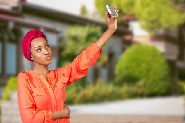 Portrait d'une femme afro-américaine souriante faisant selfie photo