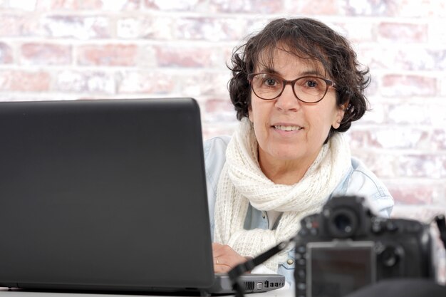 Portrait d'une femme d'âge moyen à l'aide d'un ordinateur portable