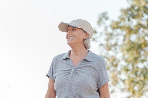 Portrait d'une femme âgée avec une expression joviale souriante regardant loin