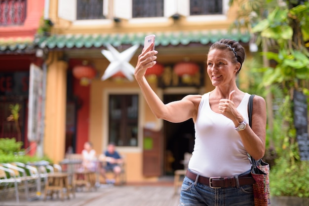 Portrait de femme belle touriste mature profitant de la vie lors d'un voyage dans la ville de Singapour