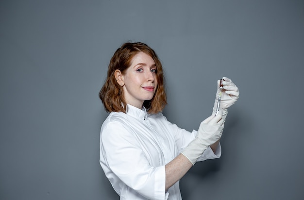 Portrait d'une femme médecin avec une seringue dans ses mains