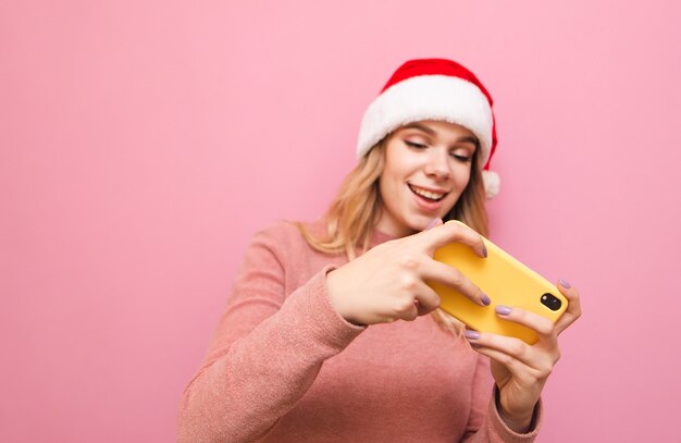 portrait femme portant bonnet de noel avec téléphone