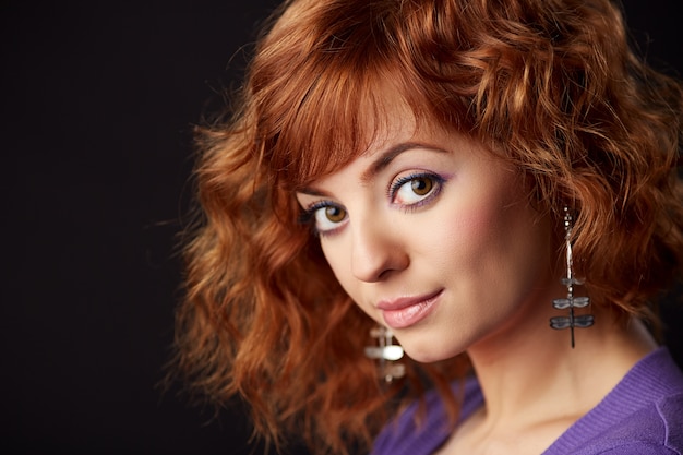 Portrait de femme rousse avec boucles d'oreilles