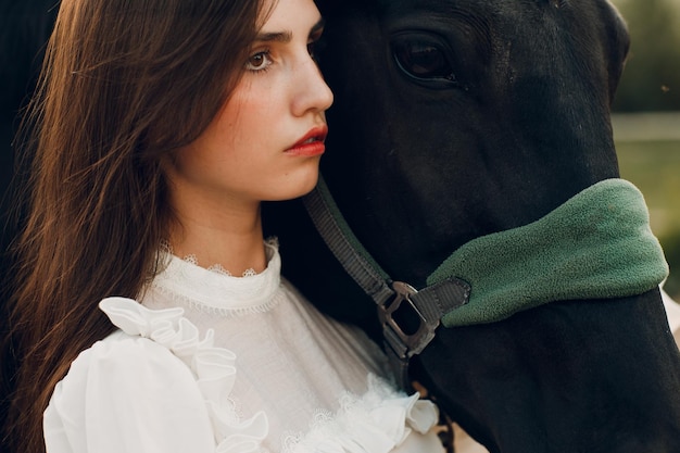 Portrait d'une femme avec sa bride de cheval à un ranch en plein air