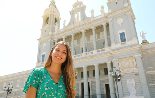 Portrait de femme souriante à Madrid avec la cathédrale de l'Almudena, Espagne