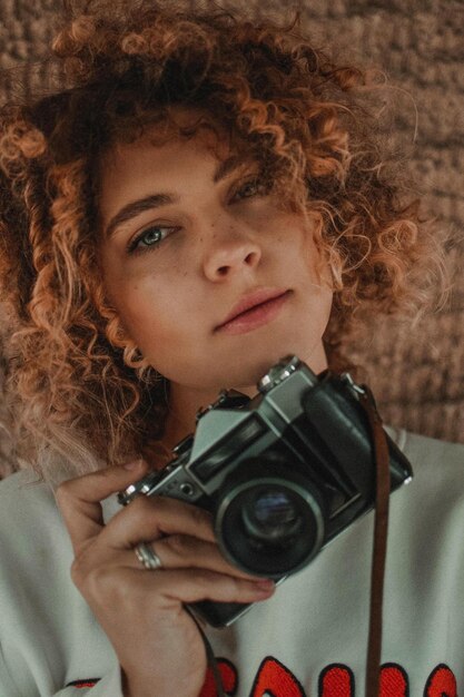 Photo portrait d'une femme tenant une caméra