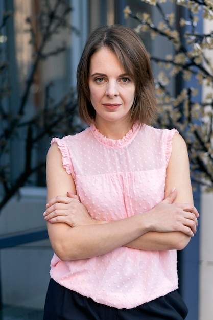 Portrait d'une femme de trente ans avec une coupe de cheveux bob en chemisier rose Style de vêtements d'affaires