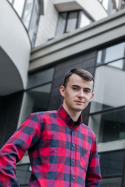 Portrait d'un gars dans une chemise à carreaux rouge