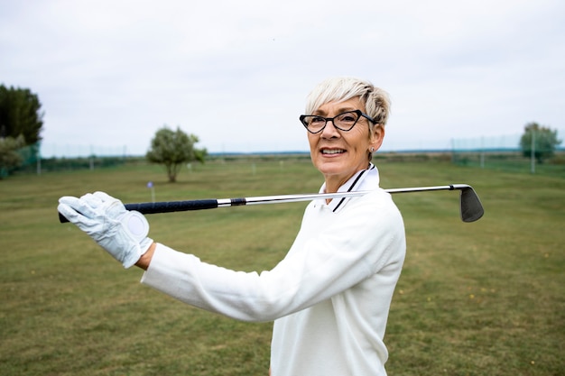 Portrait De Golfeuse Avec Club De Golf Debout Sur Le Terrain De Golf.