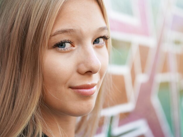 Photo portrait en gros plan d'une adolescente debout contre le mur