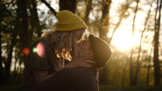 Photo portrait en gros plan d'un beau jeune couple attendant de s'embrasser pendant leur voyage contre la lumière du coucher du soleil