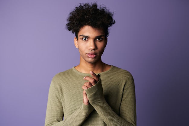 Portrait en gros plan d'un homme afro-américain transgenre avec une coiffure afro, un beau garçon regarde la caméra