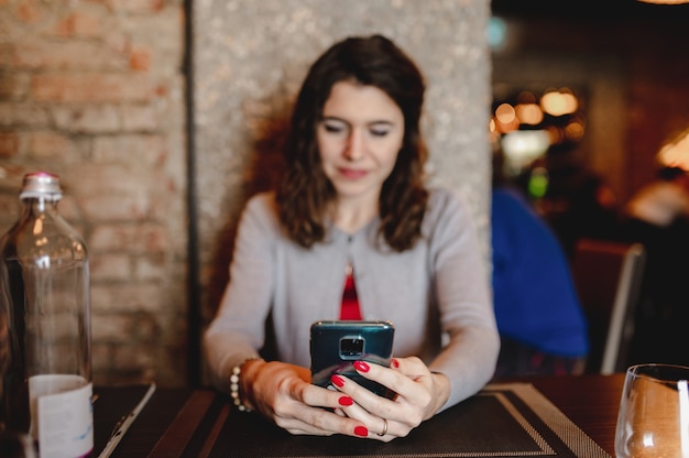 portrait en gros plan avec une jeune femme caucasienne à l'aide de smartphone. Message texte, concept technologique.