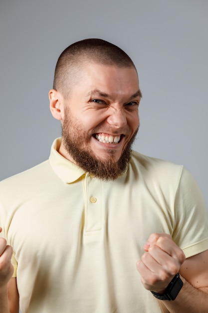 Portrait en gros plan d'un jeune homme heureux dans un T-shirt jaune