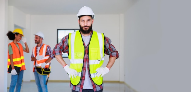 Portrait happy hispanic Construction Worker in safety hard hat helmet working on Building Site