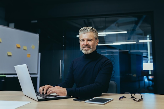 Portrait d'un homme d'affaires adulte mature senior à l'intérieur du bureau investisseur masculin aux cheveux gris sur le lieu de travail