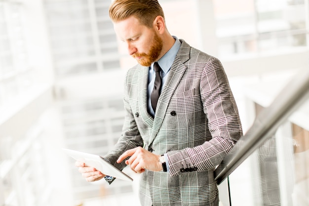 Portrait d&#39;homme d&#39;affaires confiant avec tablette sur les escaliers de bureau