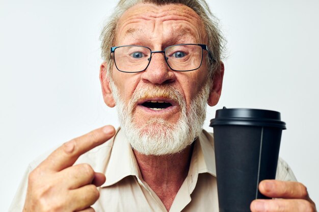 Portrait d'un homme âgé avec une barbe grise dans une chemise et des lunettes fond isolé