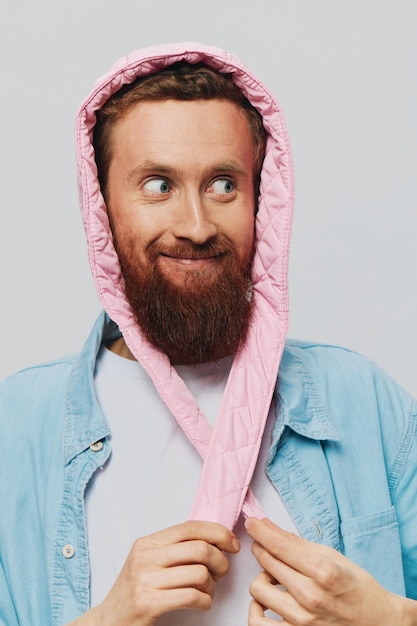 Portrait d'un homme drôle avec un chapeau rose sur un fond gris clair Sourire et émotions positives