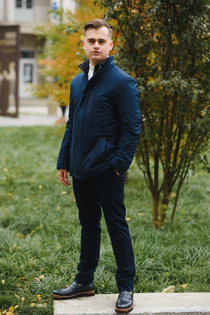 Portrait d'un homme élégant avec une barbe vêtu d'un manteau, à l'extérieur