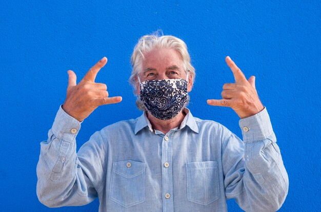 Photo portrait d'un homme faisant des gestes contre le mur bleu