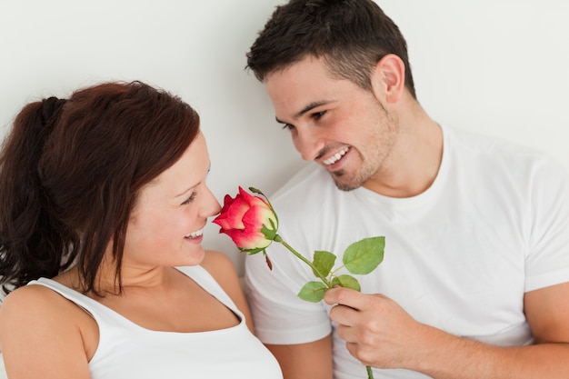 Portrait d&#39;un homme et d&#39;une femme dans un lit avec une rose