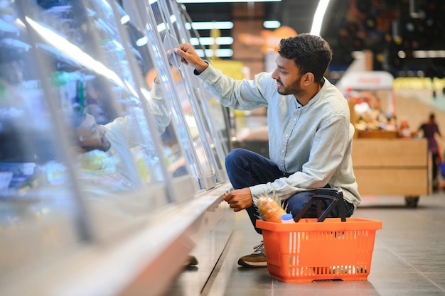 portrait d'un homme indien dans une épicerie avec une attitude positive