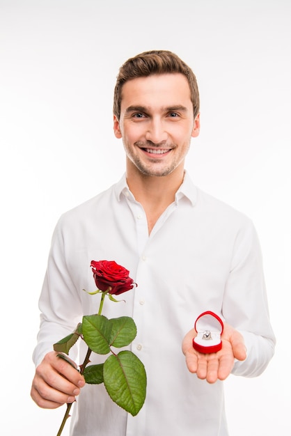 Portrait d'un homme souriant mignon, faisant une proposition avec bague de mariage