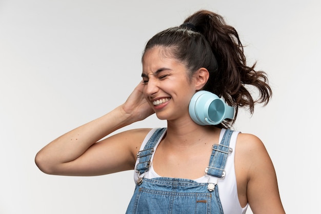 Portrait de jeune adolescente en salopette avec un casque