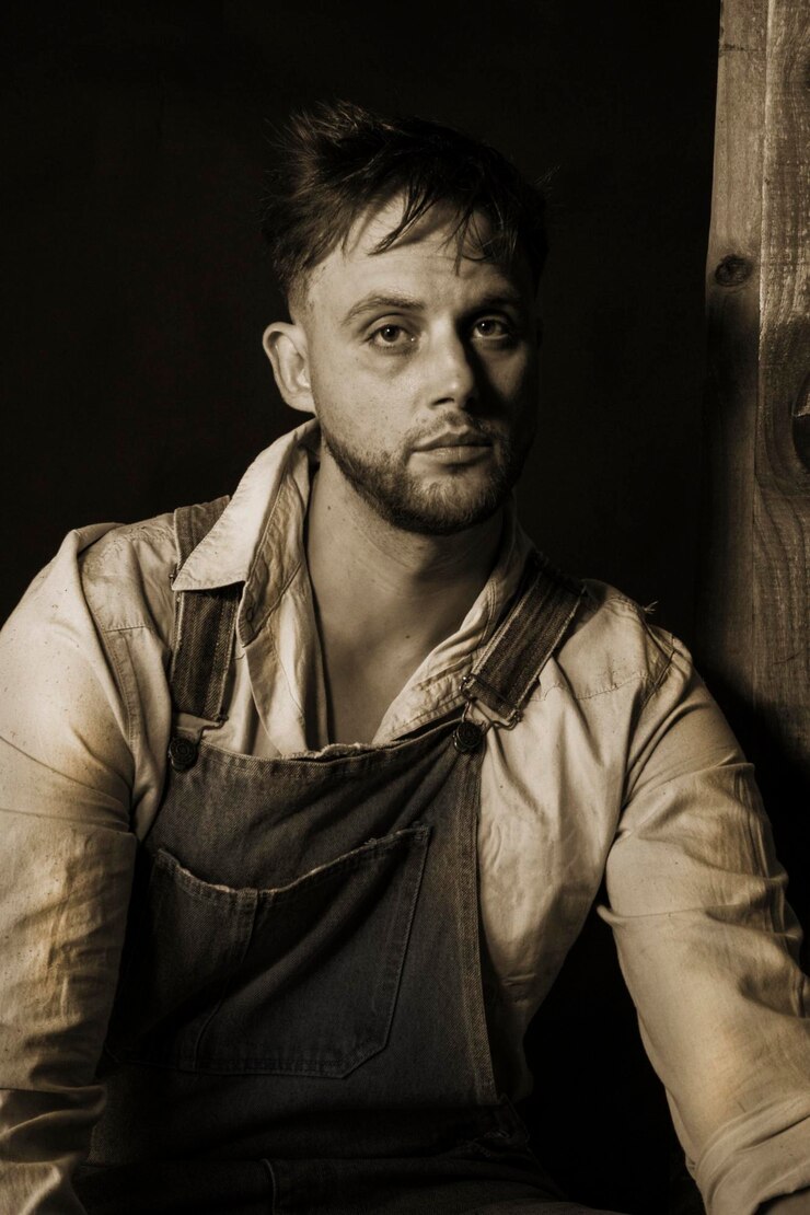 Portrait d'un jeune agriculteur en noir et blanc.