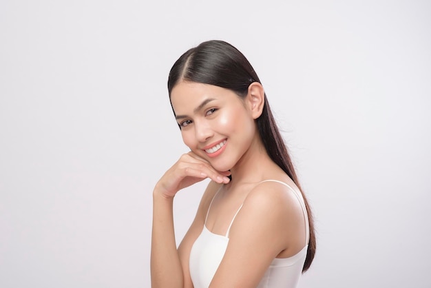 Un portrait de jeune belle femme avec une peau lisse et saine sur fond blanc, concept de soins de la peau