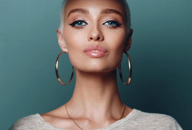 Portrait de jeune belle femme de visage avec la grande boucle d'oreille ronde d'or