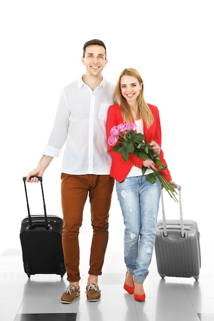 Portrait de jeune couple heureux avec bagages à l'aéroport