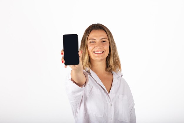 Portrait de jeune femme d'affaires avec smartphone en studio