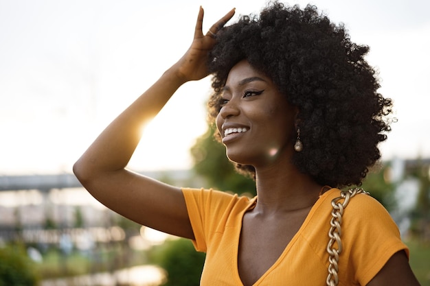 Portrait d'une jeune femme afro-américaine souriante debout dans la ville