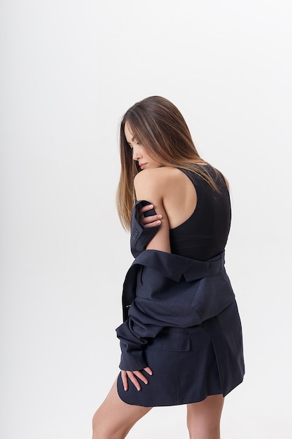 Portrait de jeune femme asiatique séduisante aux cheveux longs en body noir et costume bleu isolé sur fond de studio blanc. maigre jolie femme posant sur cyclorama. essais sur modèle de belle dame