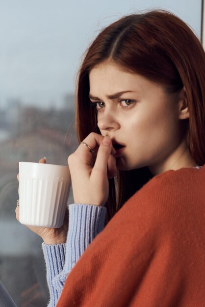 Portrait d'une jeune femme buvant du café