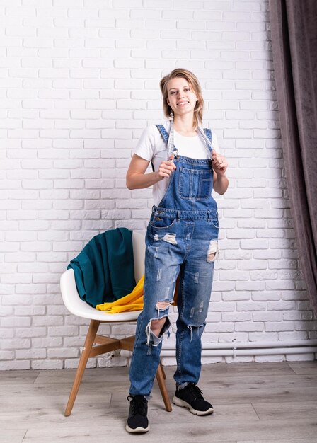 Photo portrait d'une jeune femme caucasienne tailleur tenant le textile et un compteur de bande