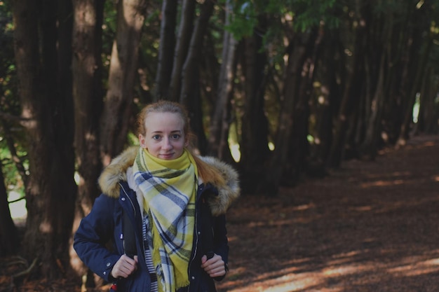 Photo portrait d'une jeune femme debout dans la forêt